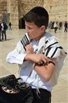 Talit and Tefilin Laying against the background the Western Wall in Jerusalem