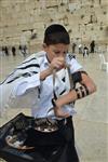 Talit and Tefilin Laying against the background the Western Wall in Jerusalem