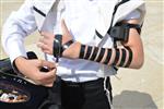 Talit and Tefilin Laying against the background the Western Wall in Jerusalem