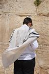 Talit and Tefilin Laying against the background the Western Wall in Jerusalem