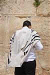 Talit and Tefilin Laying against the background the Western Wall in Jerusalem