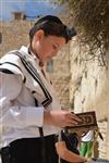 Talit and Tefilin Laying against the background the Western Wall in Jerusalem