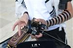 Talit and Tefilin Laying against the background the Western Wall in Jerusalem