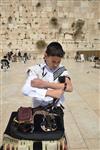 Talit and Tefilin Laying against the background the Western Wall in Jerusalem