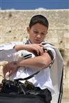 Talit and Tefilin Laying against the background the Western Wall in Jerusalem