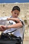 Talit and Tefilin Laying against the background the Western Wall in Jerusalem