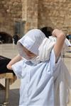 Talit and Tefilin Laying against the background the Western Wall in Jerusalem