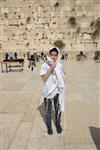 Talit and Tefilin Laying against the background the Western Wall in Jerusalem