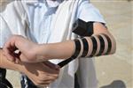 Talit and Tefilin Laying against the background the Western Wall in Jerusalem