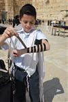 Talit and Tefilin Laying against the background the Western Wall in Jerusalem