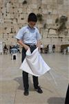 Talit and Tefilin Laying against the background the Western Wall in Jerusalem