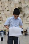 Talit and Tefilin Laying against the background the Western Wall in Jerusalem