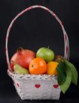 fruit in basket on black background