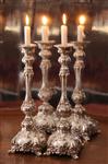 Lit Shabbos Candles on a silver background