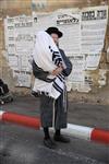 Child being led a prayer shawl towards income study cheder