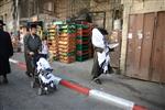 Child being led a prayer shawl towards income study cheder