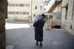 Child being led a prayer shawl towards income study cheder