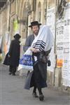 Child being led a prayer shawl towards income study cheder