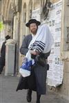 Child being led a prayer shawl towards income study cheder