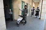 Child being led a prayer shawl towards income study cheder