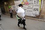 Child being led a prayer shawl towards income study cheder
