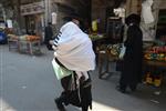 Child being led a prayer shawl towards income study cheder